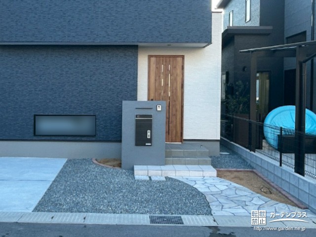 ホワイトの乱形石で舗装したおしゃれな玄関アプローチ