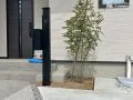 植栽の緑が引きつブラックカラーの機能門柱