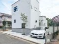 外壁の白に植栽の緑が映える爽やかな外構
