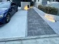 濃淡のある天然石調タイルで仕上げる玄関アプローチ