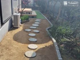 曲線がやさしく導く　ナチュラルな印象のピンコロ石花壇[施工後]