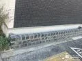 ブラックのピンコロ石で外壁に馴染む植栽スペースを施工した工事