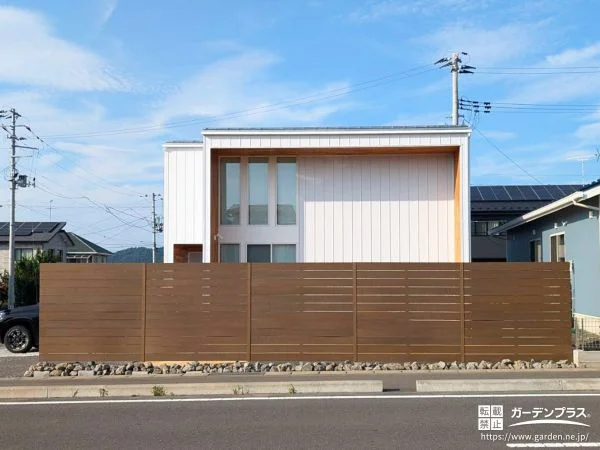 No.26683 建物の雰囲気に調和する木調フェンスと割栗石がアクセントの工事[施工後]