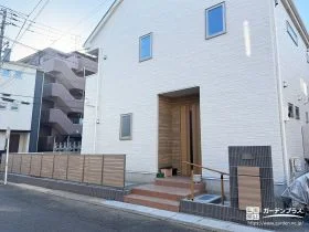 木調のアクセントが映える、高低差を解消する新築外構
