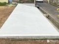 高低差のある地面をコンクリートで整えた駐車スペース工事