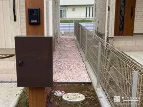 薄紅の砂利が玄関脇をやさしく彩るお手入れラクラク犬走り工事