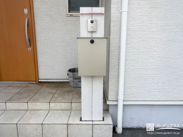 木調の機能門柱とピンコロ石目地がさりげない彩りを添えた工事