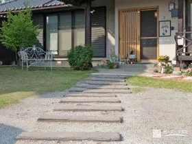 コンクリート製の枕木の小道にお気に入りの小物が並ぶ園路[施工後]